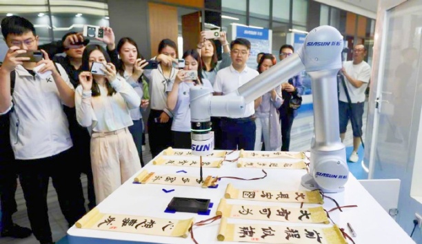中国日报网——广东深圳：蓝狮娱乐智能机器人“书法家”秀才艺
